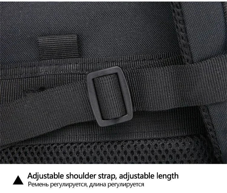 Close-up of a black backpack with an adjustable shoulder strap on a dark background.