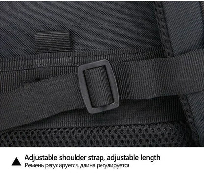 Close-up of a black backpack with an adjustable shoulder strap on a dark background.