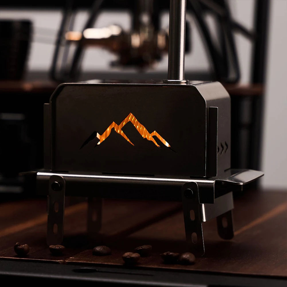 Portable stove with mountain design on a wooden surface