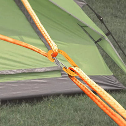 Green tent with orange ropes and carabiners on grass