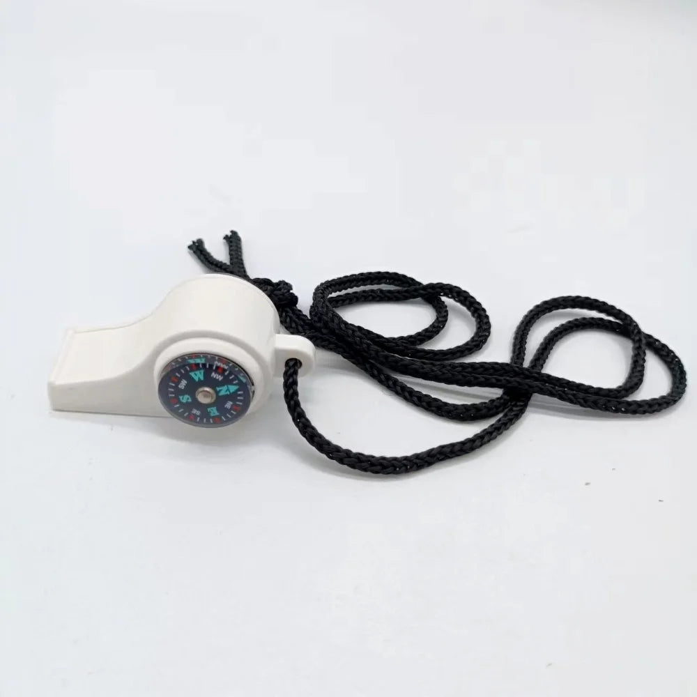 White whistle with a black cord and compass face on a white background